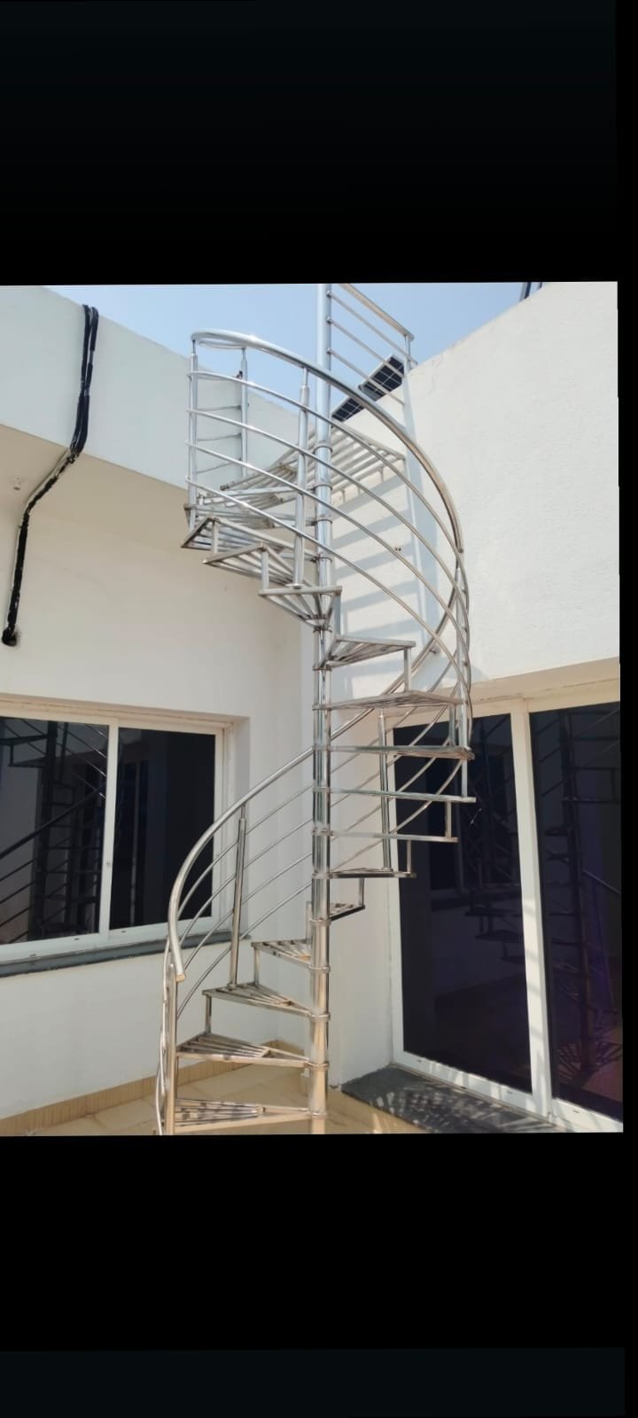 Spiral stair — polished SS on terrace