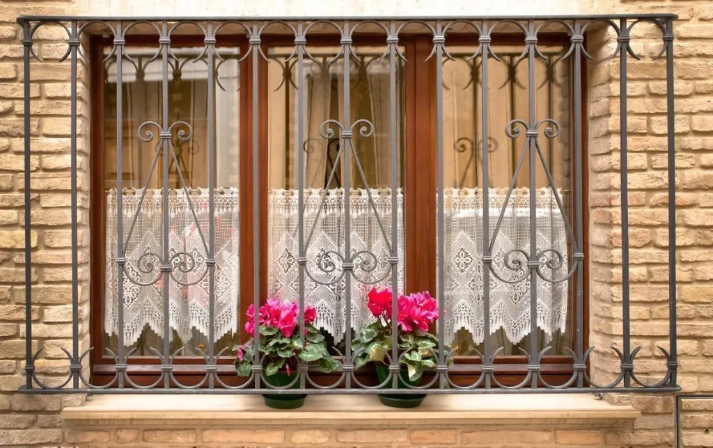 Wrought iron scroll grill — classic facade